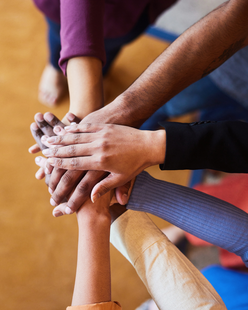 A diverse team with all hands in, working together with little to no conflict because they understand each other