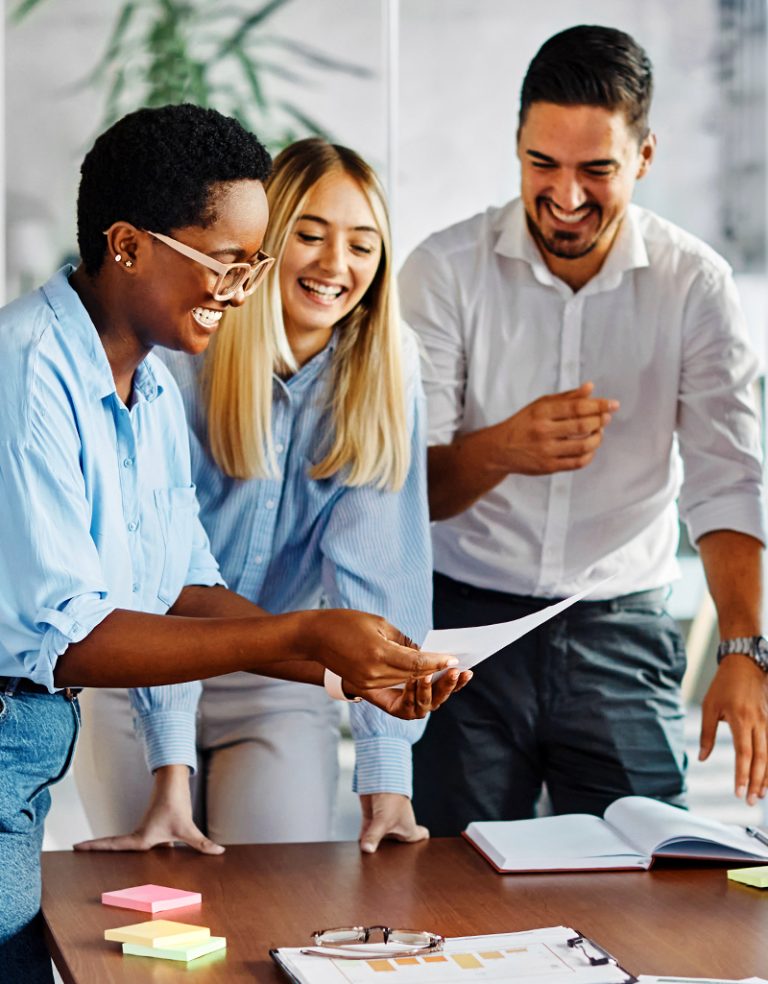 Motivated working team of three looking at a printed MCode report