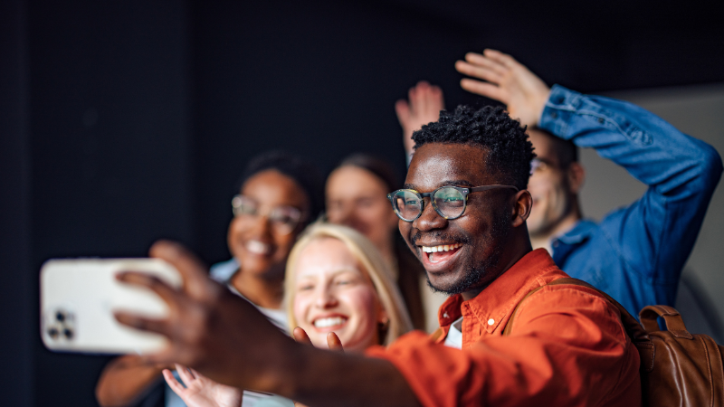 people taking group selfie with a cellphone