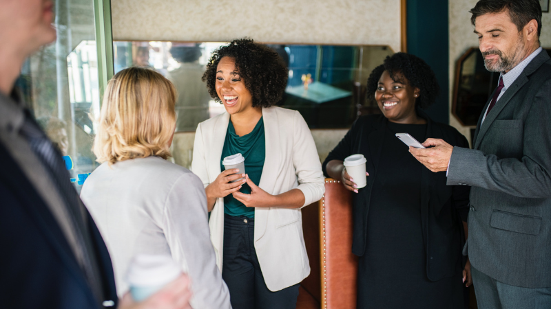 group of happy coworkers talking and smiling