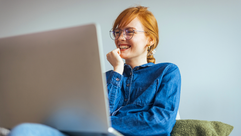 empowered woman smiling in front of her computer
