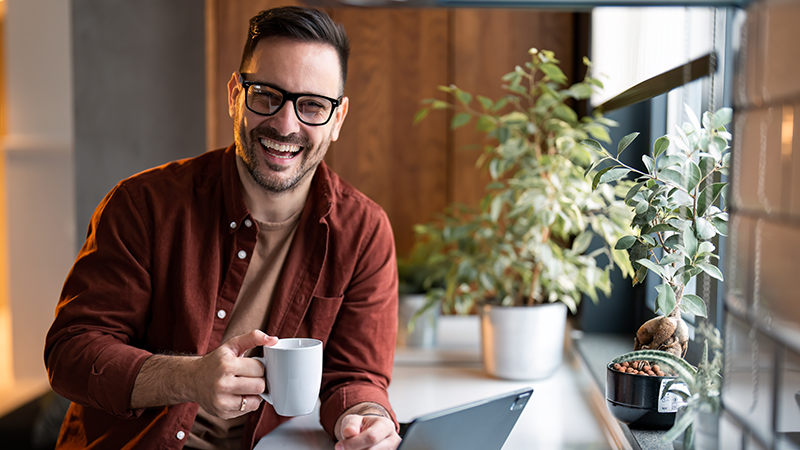man drinking coffee and feeling valued by his leaders