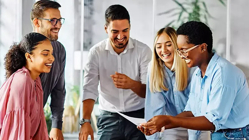 Team members laughing together while at work.