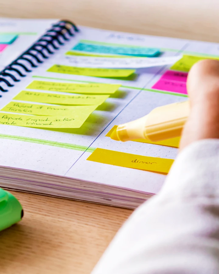 An orchestrator organizing their tasks in a weekly planner.