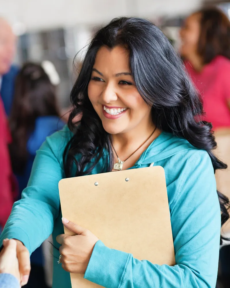A woman shaking hands after a successful job interview