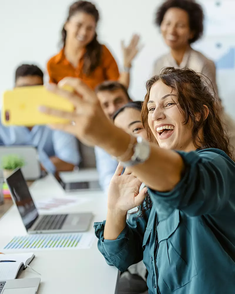 Co-workers taking a selfie at their office.