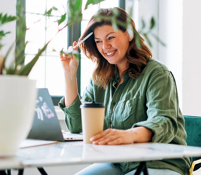 A woman on a video call smiling.
